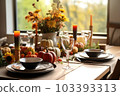 Seasonal table setting with pumpkins and flowers 103393313