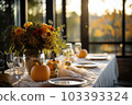 Seasonal table setting with pumpkins and flowers 103393324