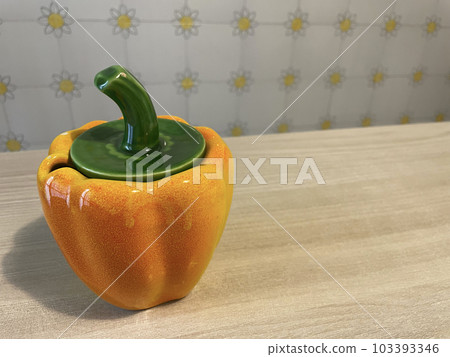 Brighten up your kitchen table with yellow paprika objects 103393346