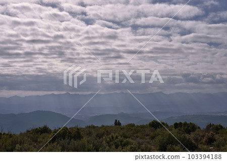 A mountain landscape with clouds and sunshine 103394188