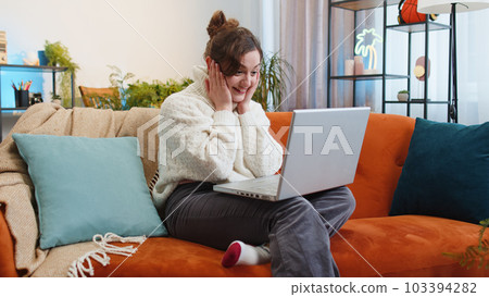 Amazed young woman use laptop computer, receive good news message, shocked by victory, celebrate win Amazed young woman use laptop computer, receive good news message, shocked by victory, celebrate win 103394282