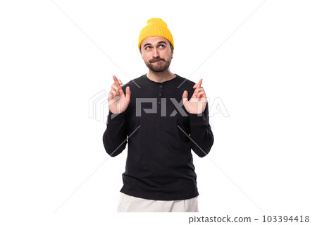 young brunette European brutal man in a black jacket prays and hopes young brunette European brutal man in a black jacket prays and hopes 103394418