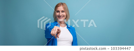 panoramic photo of confident middle aged woman in blue stylish shirt on studio background panoramic photo of confident middle aged woman in blue stylish shirt on studio background 103394447