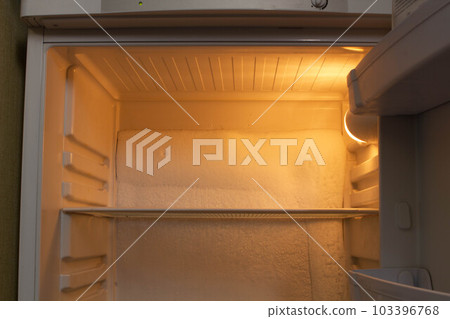 Broken refrigerator with snow inside need repairing. Icing on the back wall of the refrigerator. Freezer repaired in a service workshop. Fridge Inside view. Repair of faulty refrigeration equipment Broken refrigerator with snow inside need repairing. Icing on the back wall of the refrigerator. Freezer repaired in a service workshop. Fridge Inside view. Repair of faulty refrigeration equipment 103396768