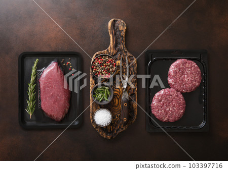 Raw fresh beef sirloin fillet steak and mince burgers sealed in vacuum tray Raw fresh beef sirloin fillet steak and mince burgers sealed in vacuum tray 103397716