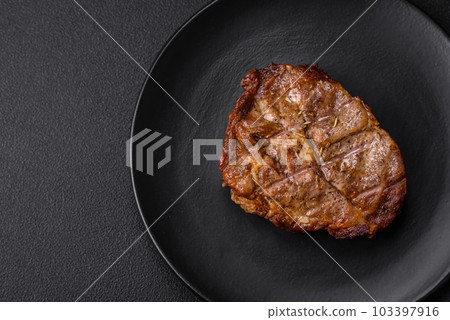Delicious juicy pork or beef steak grilled with salt, spices and herbs 103397916