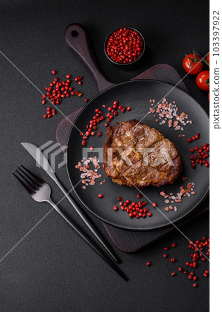 Delicious juicy pork or beef steak grilled with salt, spices and herbs Delicious juicy pork or beef steak grilled with salt, spices and herbs 103397922
