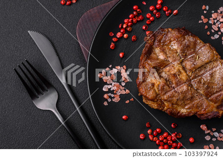 Delicious juicy pork or beef steak grilled with salt, spices and herbs Delicious juicy pork or beef steak grilled with salt, spices and herbs 103397924