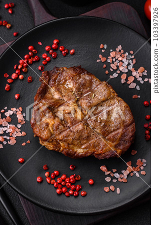 Delicious juicy pork or beef steak grilled with salt, spices and herbs 103397926