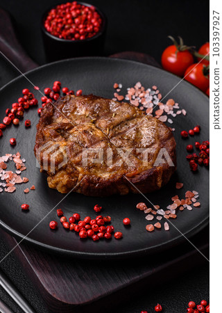 Delicious juicy pork or beef steak grilled with salt, spices and herbs 103397927