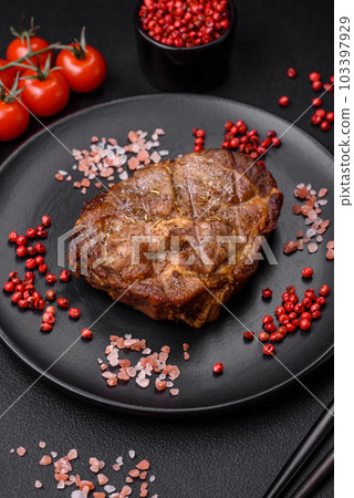 Delicious juicy pork or beef steak grilled with salt, spices and herbs 103397929