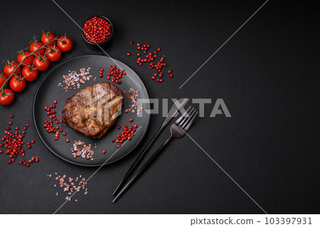 Delicious juicy pork or beef steak grilled with salt, spices and herbs 103397931