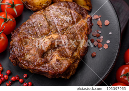 Delicious juicy pork or beef steak grilled with salt, spices and herbs 103397963