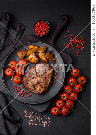 Delicious juicy pork or beef steak grilled with salt, spices and herbs 103397968