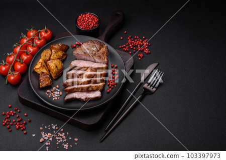 Delicious juicy pork or beef steak grilled with salt, spices and herbs Delicious juicy pork or beef steak grilled with salt, spices and herbs 103397973