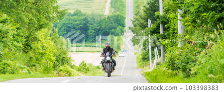 "Hokkaido" Biker running along the roller coaster road, Kamifurano Hakkei 103398383