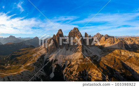 The rocky peaks of Tre Chime di Lavaredo sunset. The edges of the high peaks lighted by the rays of the sun The rocky peaks of Tre Chime di Lavaredo sunset. The edges of the high peaks lighted by the rays of the sun 103398922