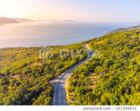 Winding coastal road, rocky cliffs and blue sea in sunny morning. Istria, Croatia Winding coastal road, rocky cliffs and blue sea in sunny morning. Istria, Croatia 103399631