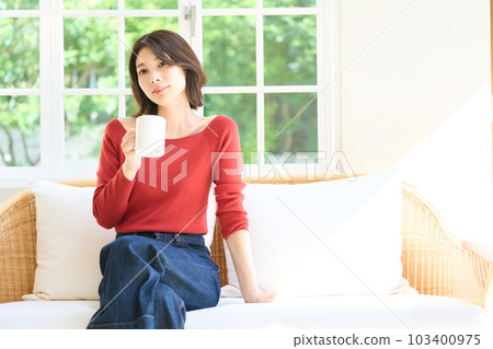 客廳裡一個穿著便衣的年輕女人 103400975