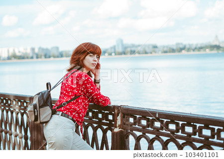 the girl on the embankment is standing with her back the girl on the embankment is standing with her back 103401101