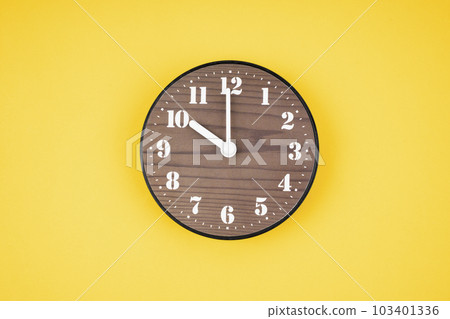 The Retro wooden clock at 10 O' clock on yellow color background. The Retro wooden clock at 10 O' clock on yellow color background. 103401336