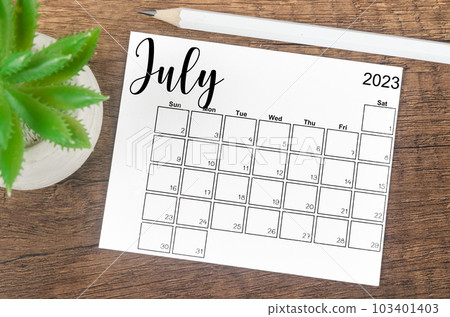 The July 2023 Monthly calendar for 2023 year with wooden pencil on wooden table. The July 2023 Monthly calendar for 2023 year with wooden pencil on wooden table. 103401403