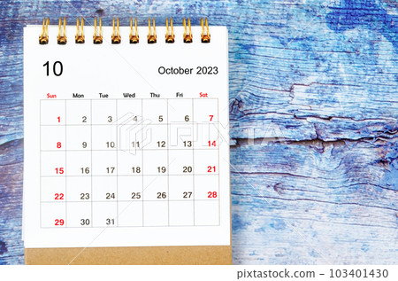 The October 2023 Monthly desk calendar for 2023 year on old blue wooden background. The October 2023 Monthly desk calendar for 2023 year on old blue wooden background. 103401430