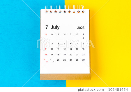 The July 2023 Monthly desk calendar for 2023 year on blue and yellow background. 103401454