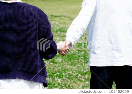 A couple holding hands A couple holding hands 103402069