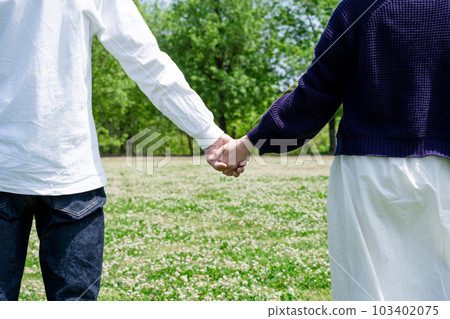 A couple holding hands A couple holding hands 103402075