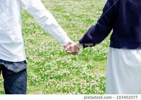 A couple holding hands A couple holding hands 103402077