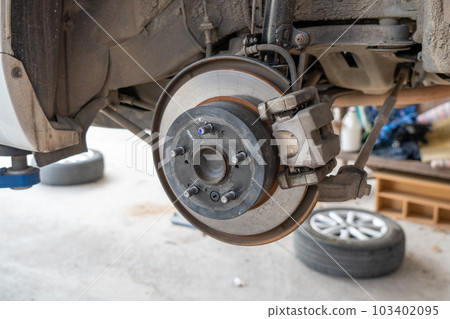 Car front disc break being checked and inspected for safety Car front disc break being checked and inspected for safety 103402095