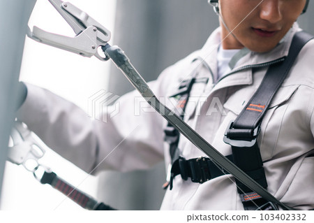 A young craftsman working at a height in building construction Faceless A young craftsman working at a height in building construction Faceless 103402332