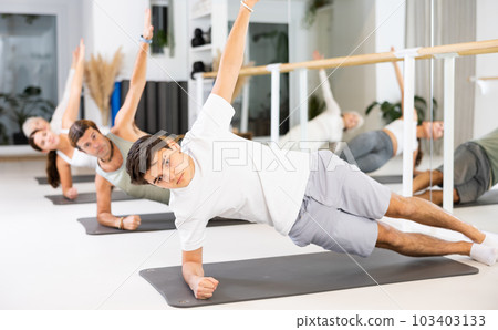 Young boy doing pilates in gym 103403133