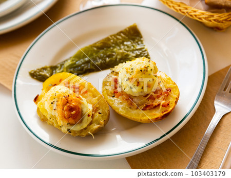 Twice baked potatoes stuffed with meat, jam, cheese and egg Twice baked potatoes stuffed with meat, jam, cheese and egg 103403179