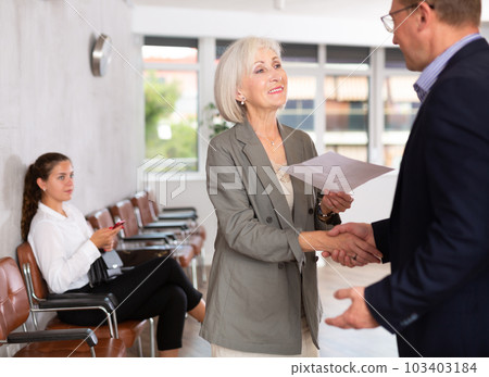 Adult man and elderly woman make an agreement 103403184