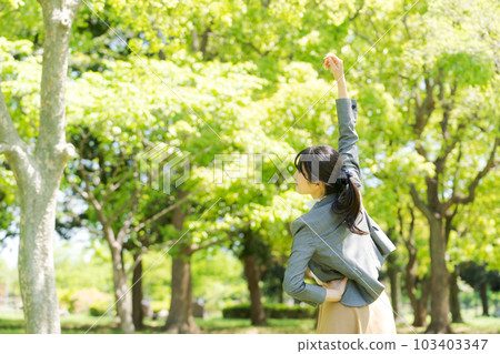 Image of a woman in a suit exercising in fresh green Image of a woman in a suit exercising in fresh green 103403347