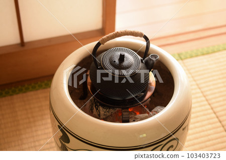 A brazier with a steaming Nanbu Tekki teapot A brazier with a steaming Nanbu Tekki teapot 103403723