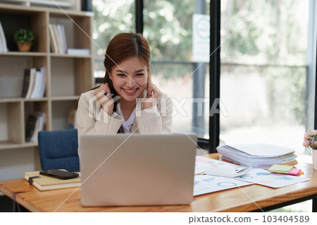 Asian Business person makes analysis and research financial report at office, analyzes profits. Accountant checks status of financial Asian Business person makes analysis and research financial report at office, analyzes profits. Accountant checks status of financial 103404589