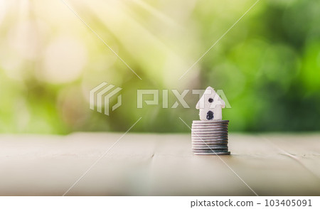 House placed on coins. planning savings money of coins to buy a home concept, concept for property ladder, mortgage and real estate investment. House placed on coins. planning savings money of coins to buy a home concept, concept for property ladder, mortgage and real estate investment. 103405091