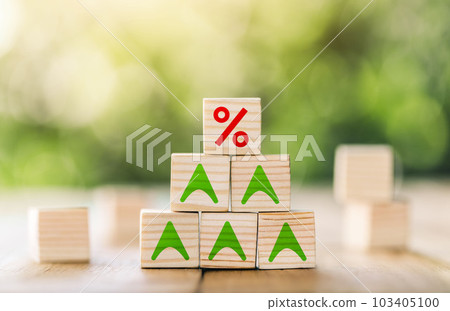 Interest rate financial and mortgage rates concept. Wooden cube block with interest rate and up arrow. Interest rate financial and mortgage rates concept. Wooden cube block with interest rate and up arrow. 103405100