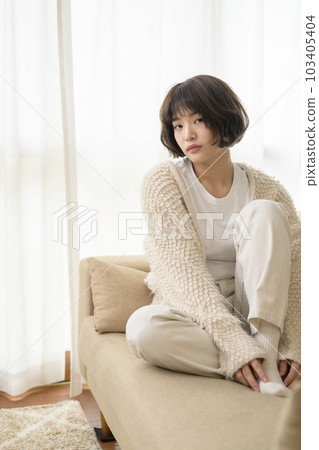 Young woman relaxing on a sofa 103405404