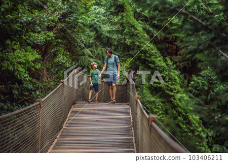 father and son tourists in Rope bridge in Yildiz Park. Besiktas, Istanbul, Turkey. Turkiye. Traveling with kids concept 103406211