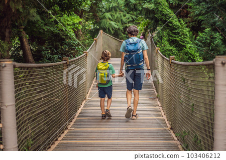 father and son tourists in Rope bridge in Yildiz Park. Besiktas, Istanbul, Turkey. Turkiye. Traveling with kids concept 103406212