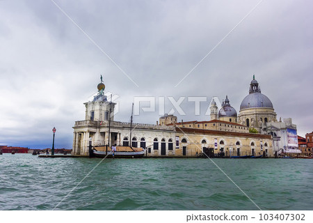 Canal in Venice from Punta della Dogana and the domes of Santa Maria della Salute. May 2023 Canal in Venice from Punta della Dogana and the domes of Santa Maria della Salute. May 2023 103407302