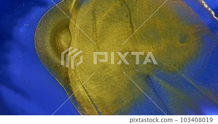 Golden waves flow over blue paint abstract background. Slow motion. Golden yellow ink splash flowing over bright blue liquid surface. Rich deep color texture. Acrylic fluid art. Shiny artwork backdrop Golden waves flow over blue paint abstract background. Slow motion. Golden yellow ink splash flowing over bright blue liquid surface. Rich deep color texture. Acrylic fluid art. Shiny artwork backdrop 103408019