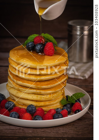 Recipe for maple syrup pancakes with raspberry and blueberry filling Recipe for maple syrup pancakes with raspberry and blueberry filling 103408928