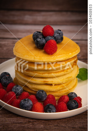 Recipe for maple syrup pancakes with raspberry and blueberry filling Recipe for maple syrup pancakes with raspberry and blueberry filling 103408933