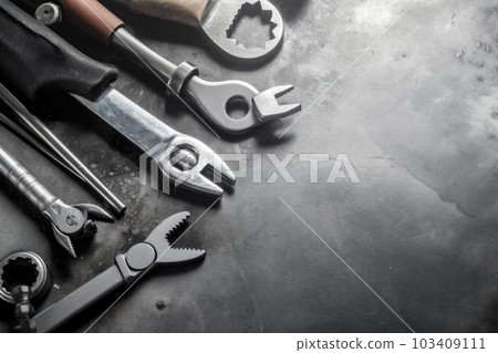 Auto mechanic's tools on grey stone table with copy space Auto mechanic's tools on grey stone table with copy space 103409111