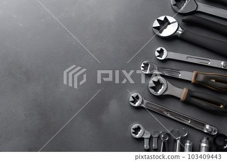 Auto mechanic's tools on grey stone table with copy space Auto mechanic's tools on grey stone table with copy space 103409443